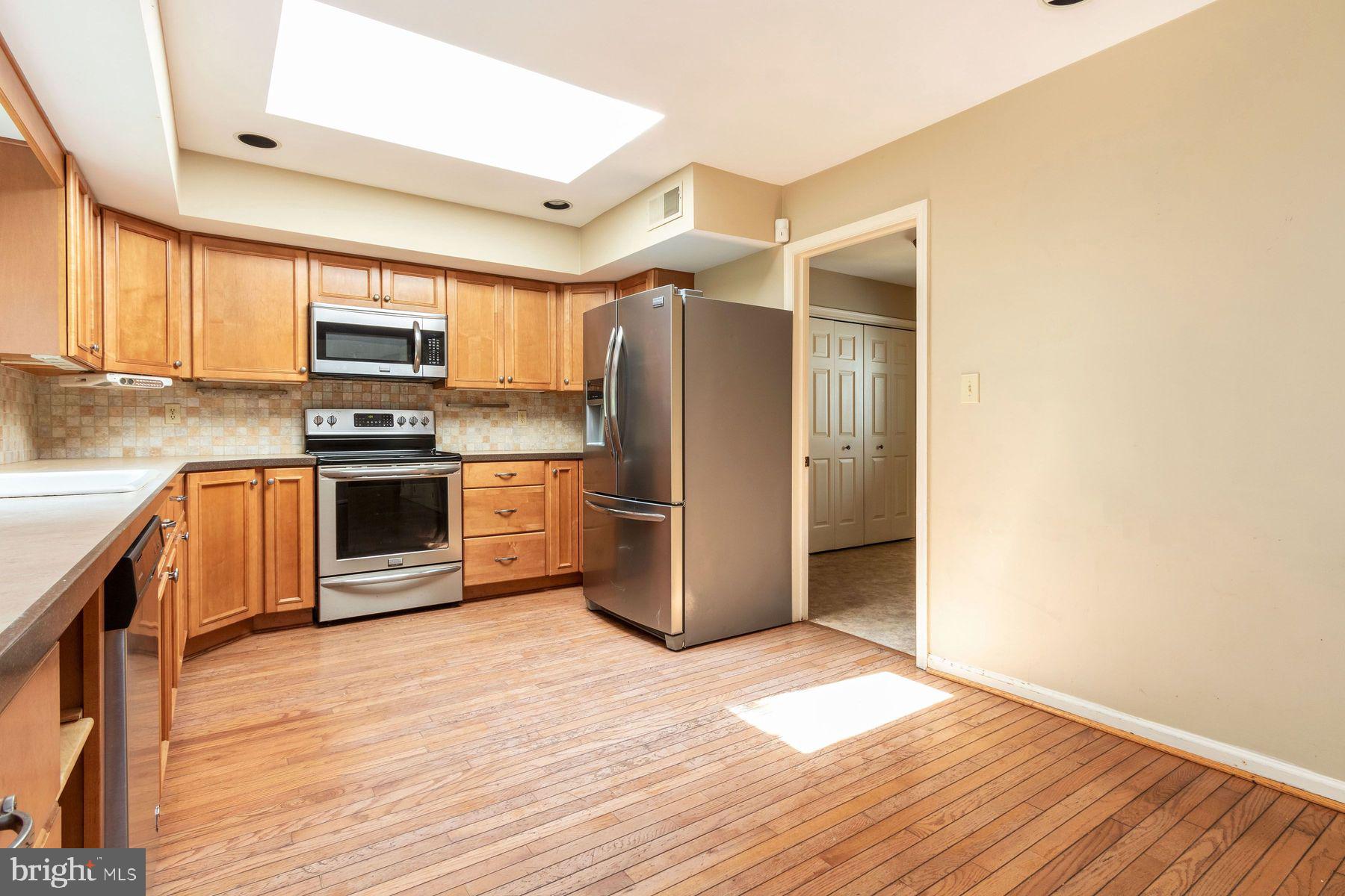 4887 Danielle Drive Doylestown, PA 18902 - Photo 24 of 35 a kitchen with stainless steel appliances granite countertop a stove a refrigerator and a sink