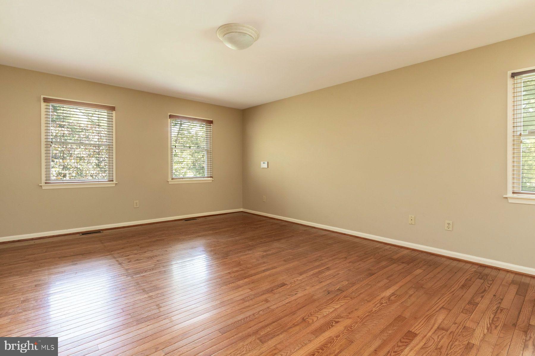 4887 Danielle Drive Doylestown, PA 18902 - Photo 26 of 35 a view of an empty room with wooden floor and window