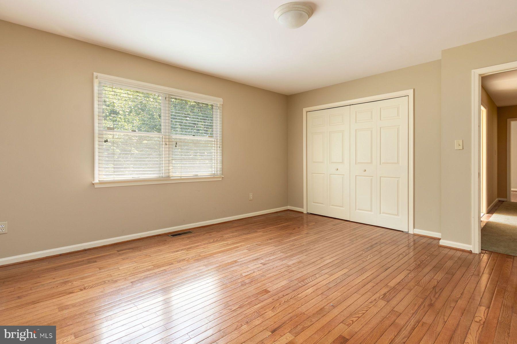 4887 Danielle Drive Doylestown, PA 18902 - Photo 30 of 35 a view of an empty room with wooden floor and a window