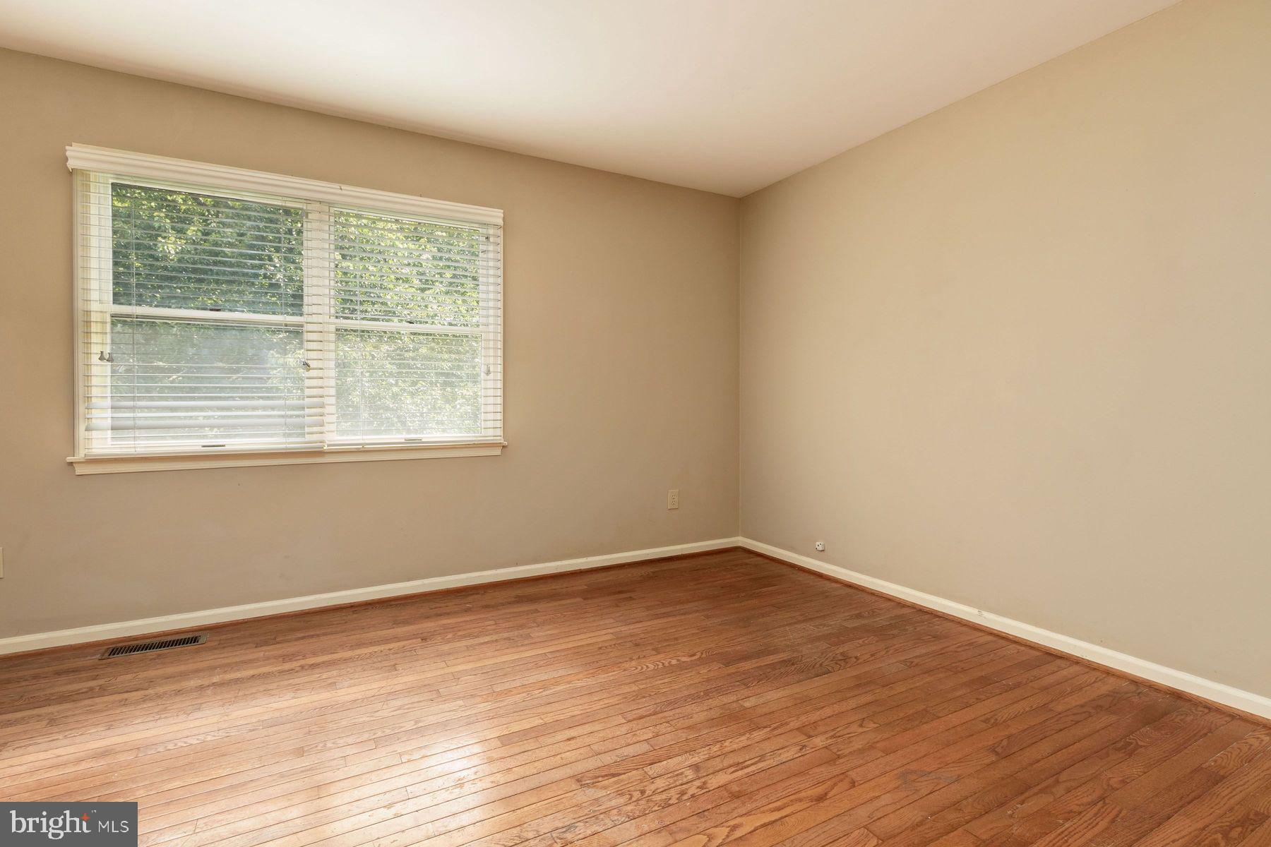 4887 Danielle Drive Doylestown, PA 18902 - Photo 31 of 35 a view of an empty room with wooden floor and a window