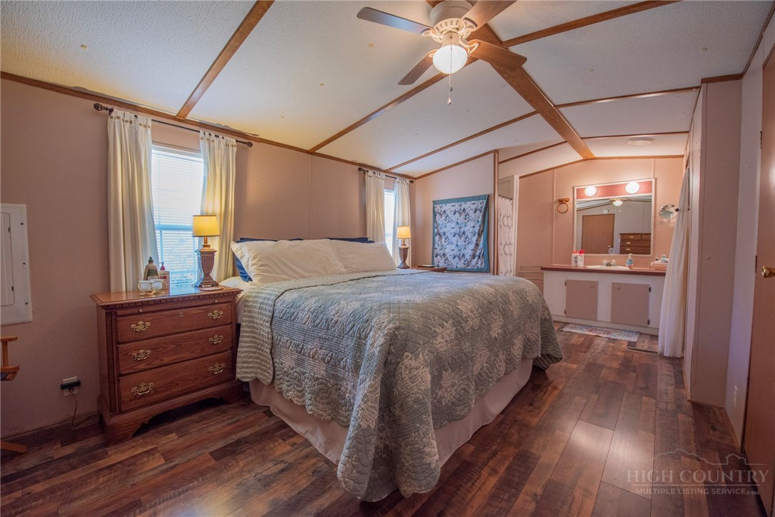 1848 West Mill Creek Road Warrensville, NC 28693 - Photo 28 of 50 a bedroom with a bed and a mirror