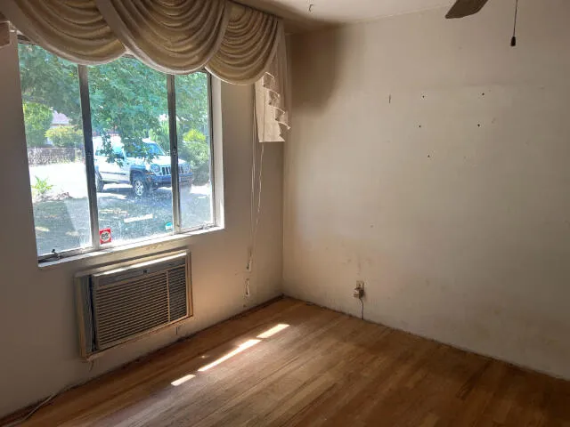 a view of a room with a large window and furniture