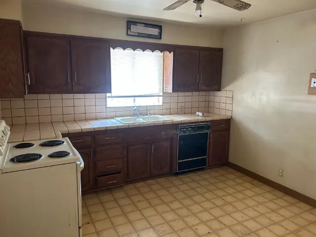 a kitchen with a sink stove and cabinets