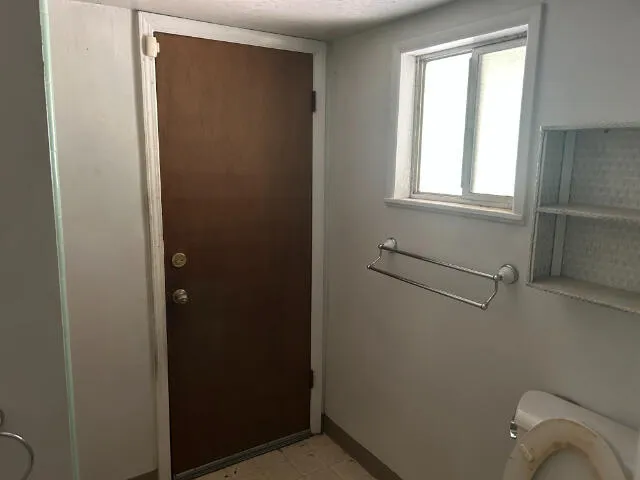 a bathroom with a window and toilet