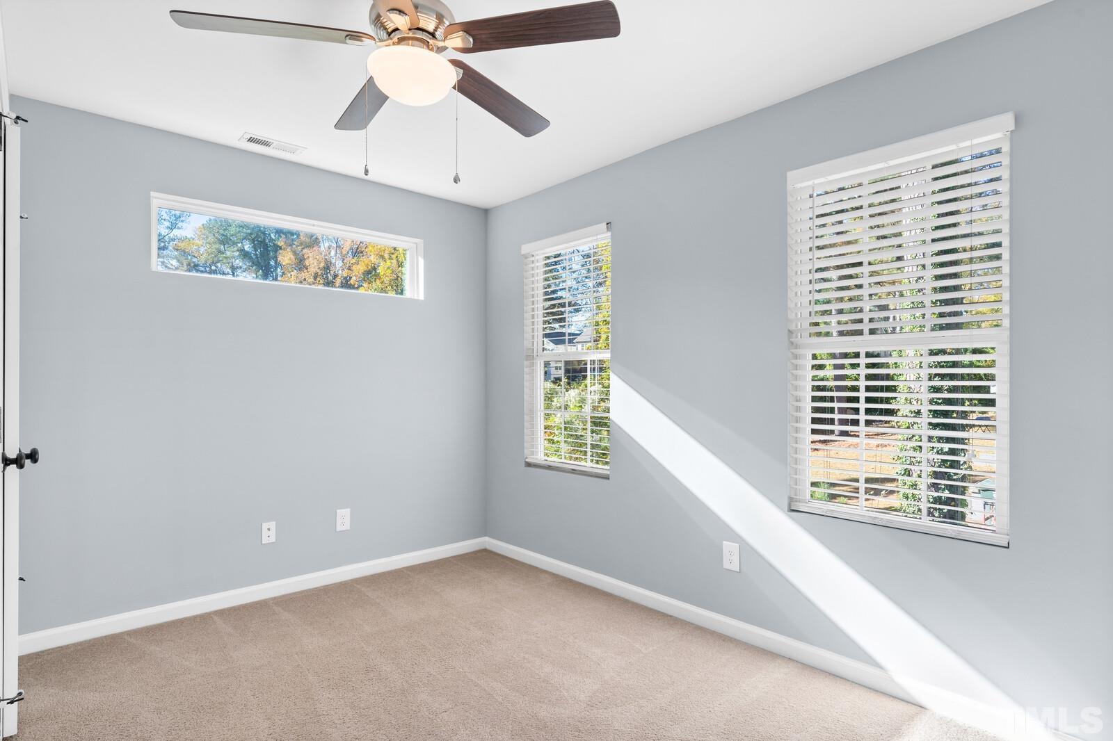 129 Pineland Circle, Unit 100 Raleigh, NC 27606 - Photo 15 of 29 a view of an empty room with a window