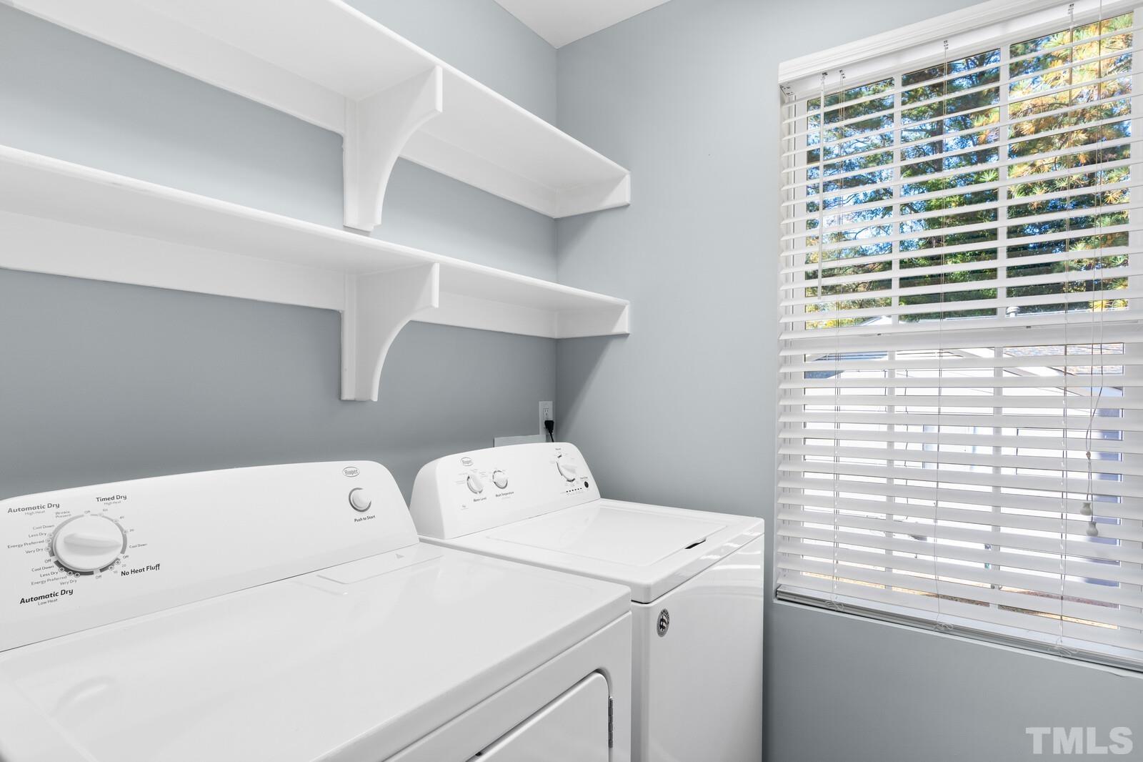 129 Pineland Circle, Unit 100 Raleigh, NC 27606 - Photo 16 of 29 a utility room with dryer and washer