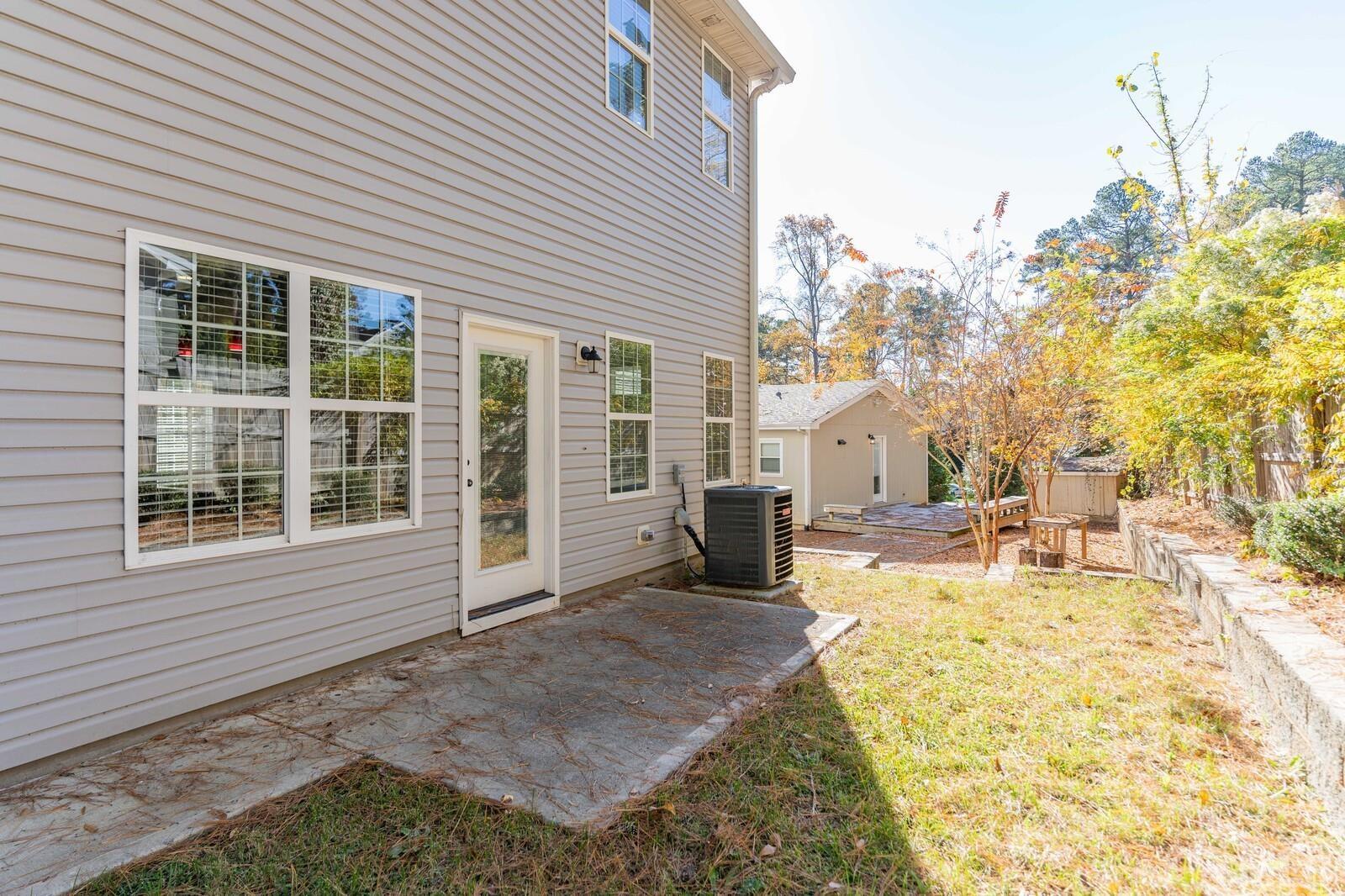 129 Pineland Circle, Unit 100 Raleigh, NC 27606 - Photo 17 of 29 a view of a house with a patio