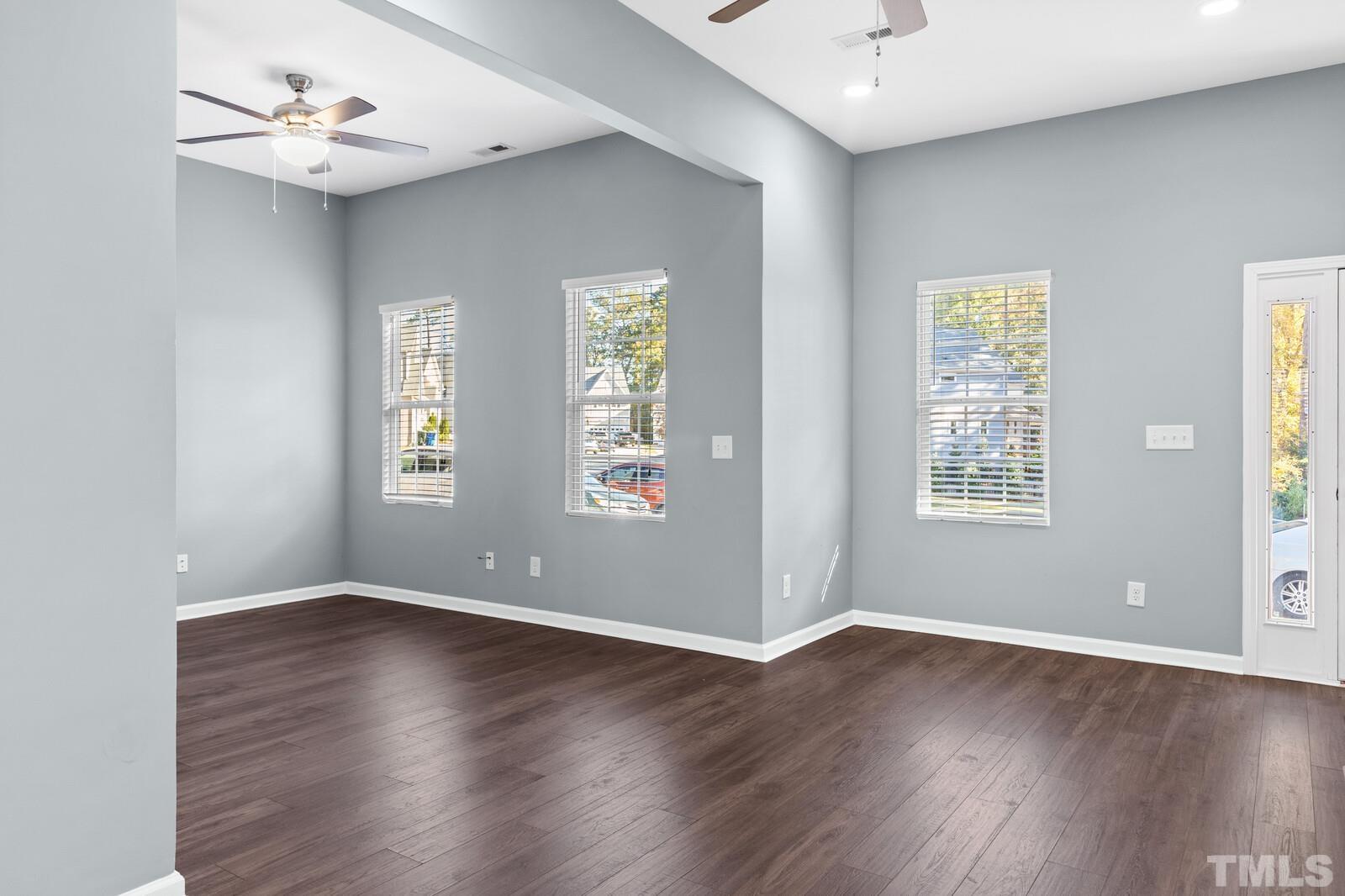 129 Pineland Circle, Unit 100 Raleigh, NC 27606 - Photo 20 of 29 a view of an empty room with wooden floor and a window