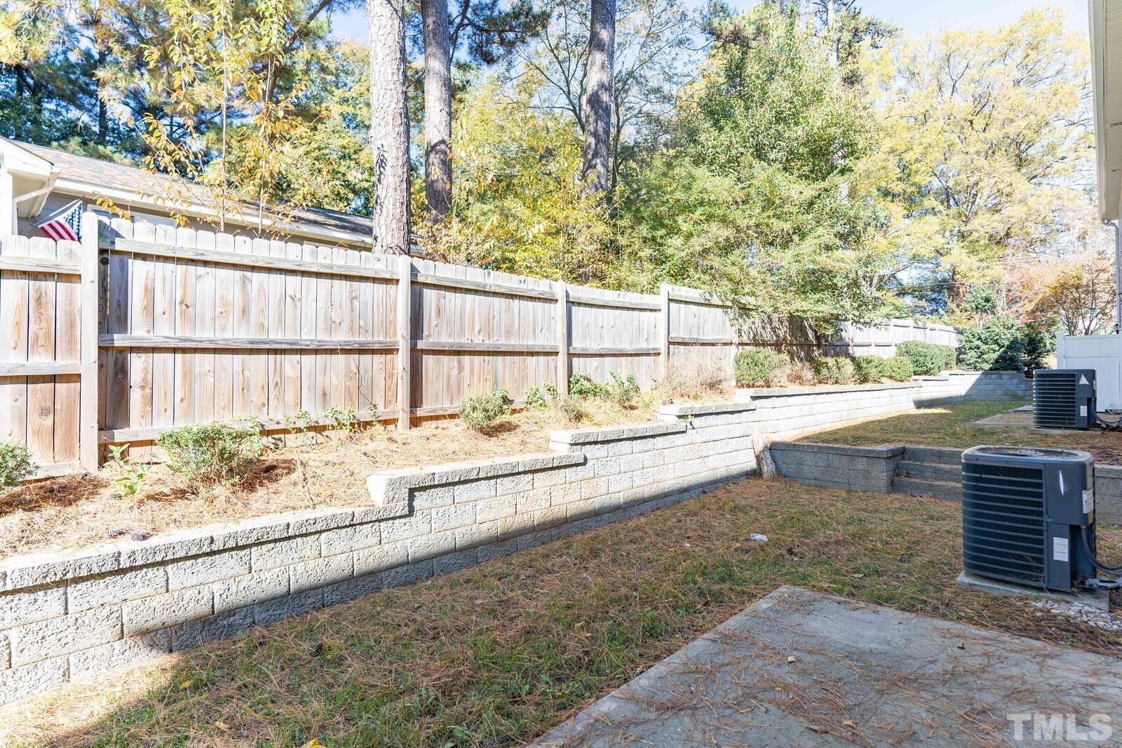 129 Pineland Circle, Unit 100 Raleigh, NC 27606 - Photo 25 of 29 a view of a swimming pool with a patio and a yard