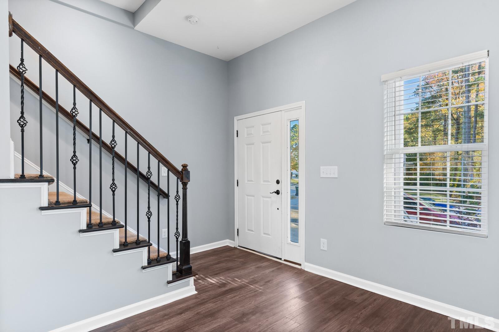 129 Pineland Circle, Unit 100 Raleigh, NC 27606 - Photo 4 of 29 a view of an entryway with wooden floor and stairs