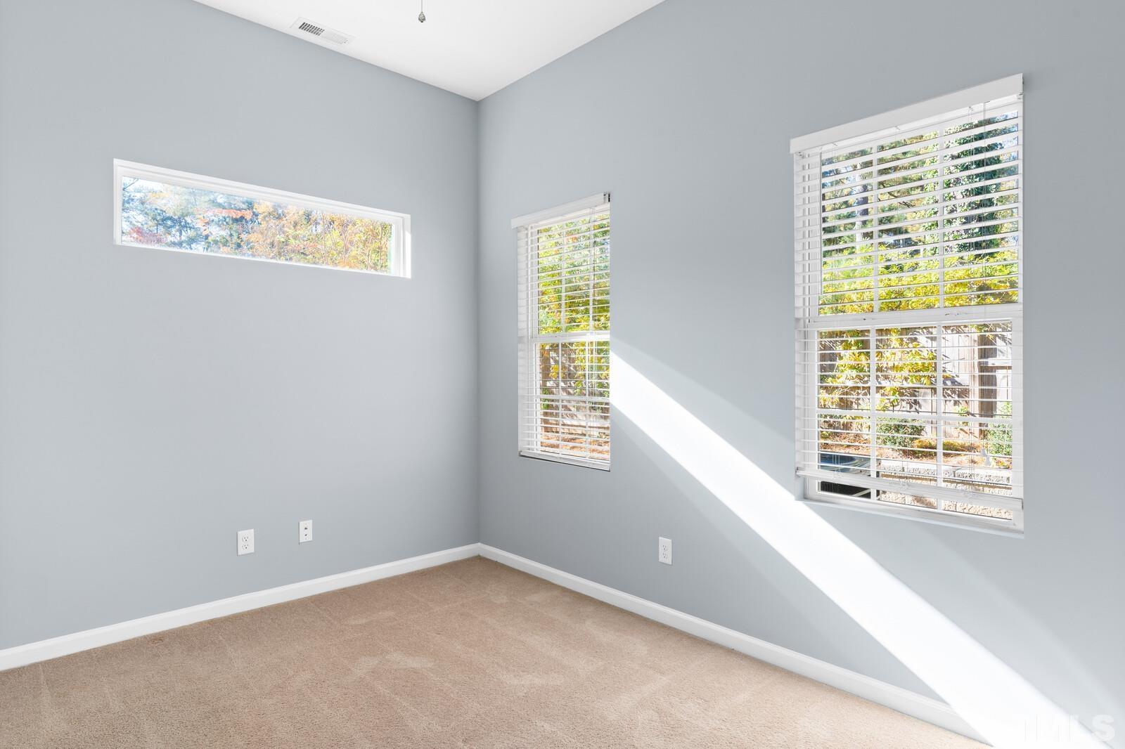 129 Pineland Circle, Unit 100 Raleigh, NC 27606 - Photo 10 of 29 a view of an empty room with a window