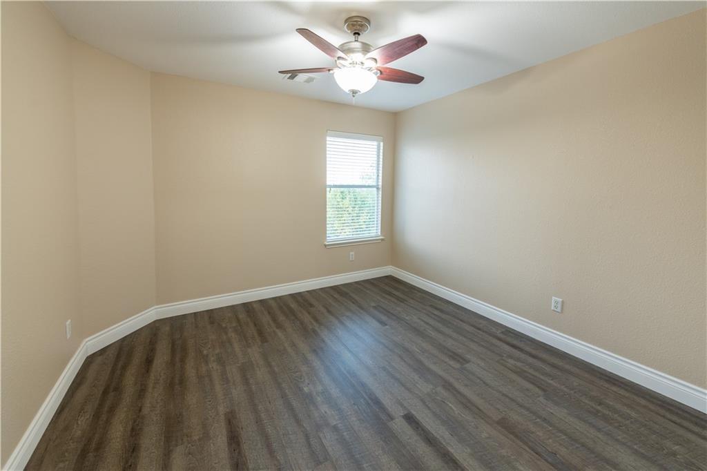 12017 Springs Head Loop Austin, TX 78717 - Photo 21 of 25 Well-lit interior space features sleek wood flooring and an overhead ceiling fan for optimal comfort.