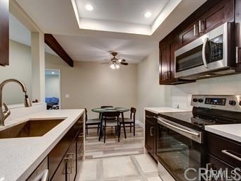 20702 El Toro Road, Unit 188 Lake Forest, CA 92630 - Photo 1 of 1 a kitchen with a stove cabinets and microwave