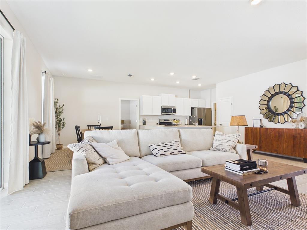 3498 Southwest 130th Ln Road Ocala, FL 34473 - Photo 12 of 31 a living room with furniture and a large window