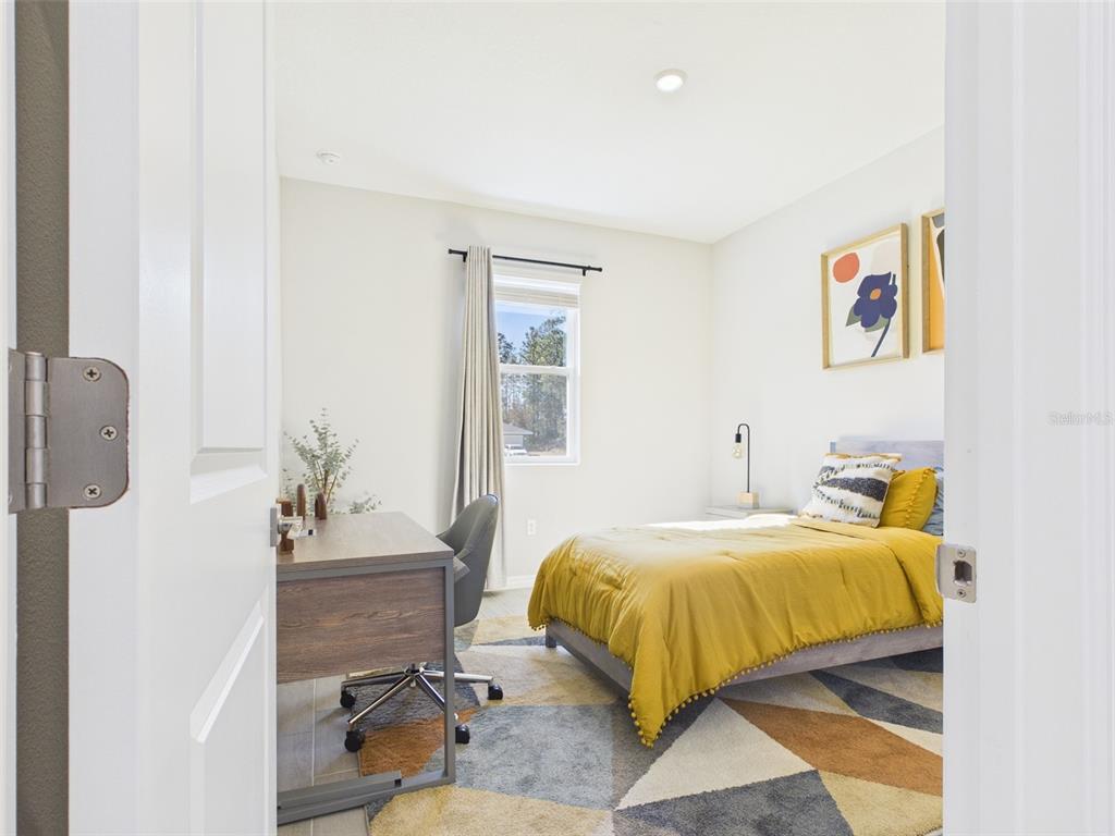 3498 Southwest 130th Ln Road Ocala, FL 34473 - Photo 24 of 31 a bedroom with a bed and wooden floor