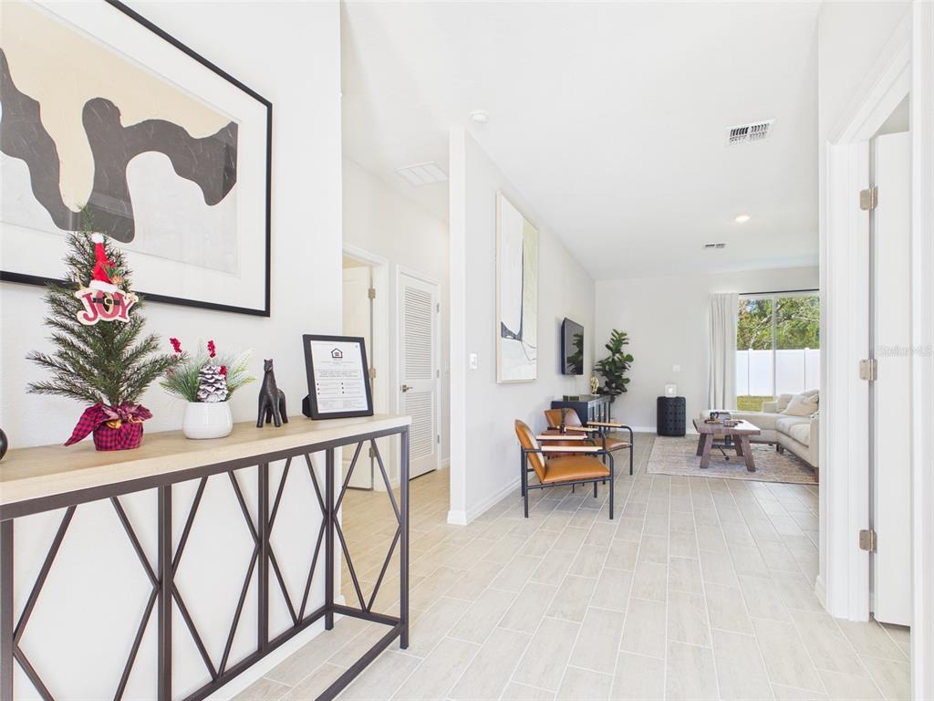 3498 Southwest 130th Ln Road Ocala, FL 34473 - Photo 4 of 31 a living room with furniture and a potted plant