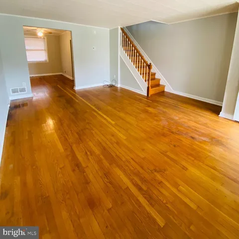 a view of an empty room with stairs and ventilation