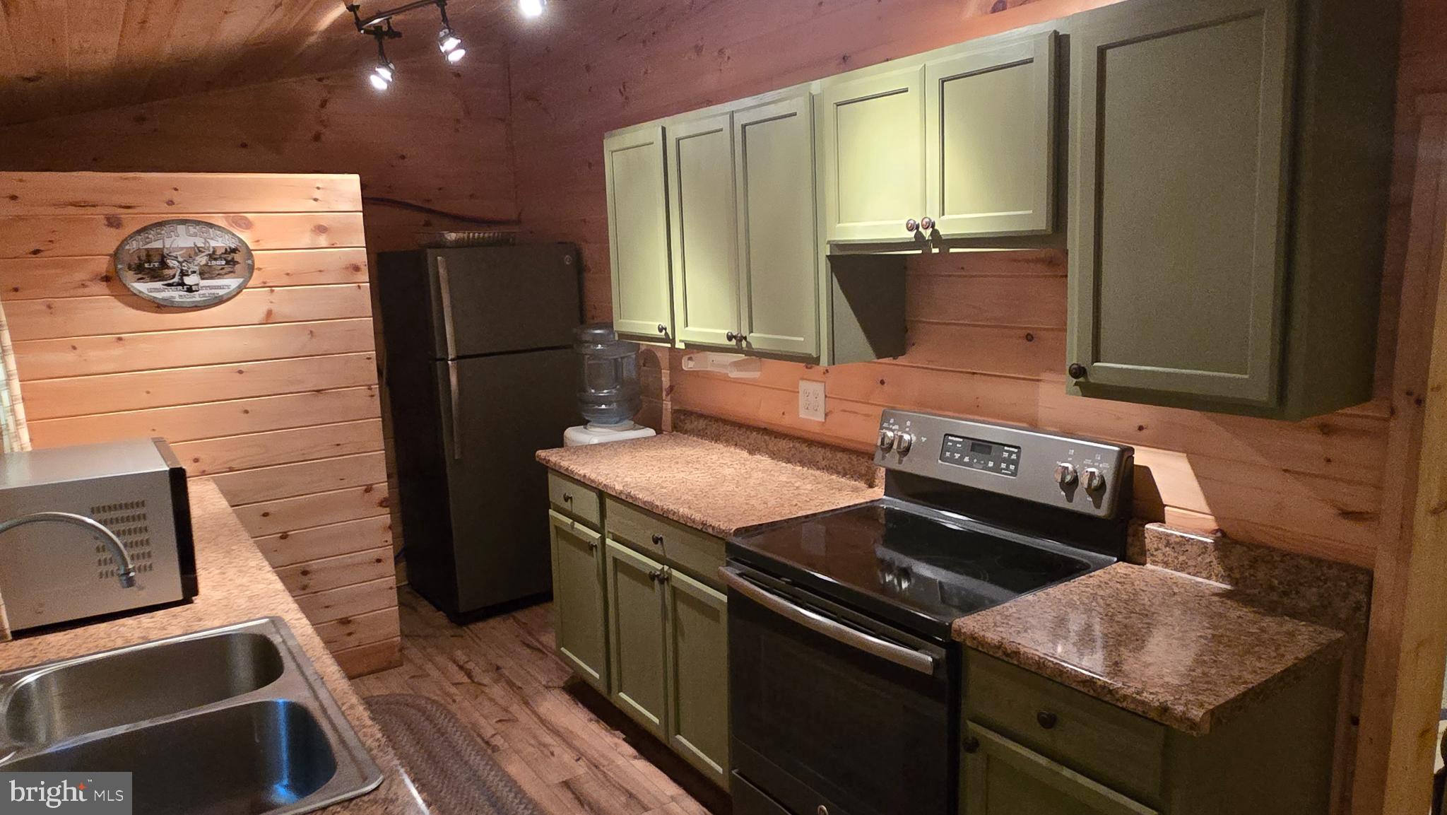 212 Thickhead Mountain Road Centre Hall, PA 16828 - Photo 17 of 28 Cozy cabin kitchen with rustic charm.