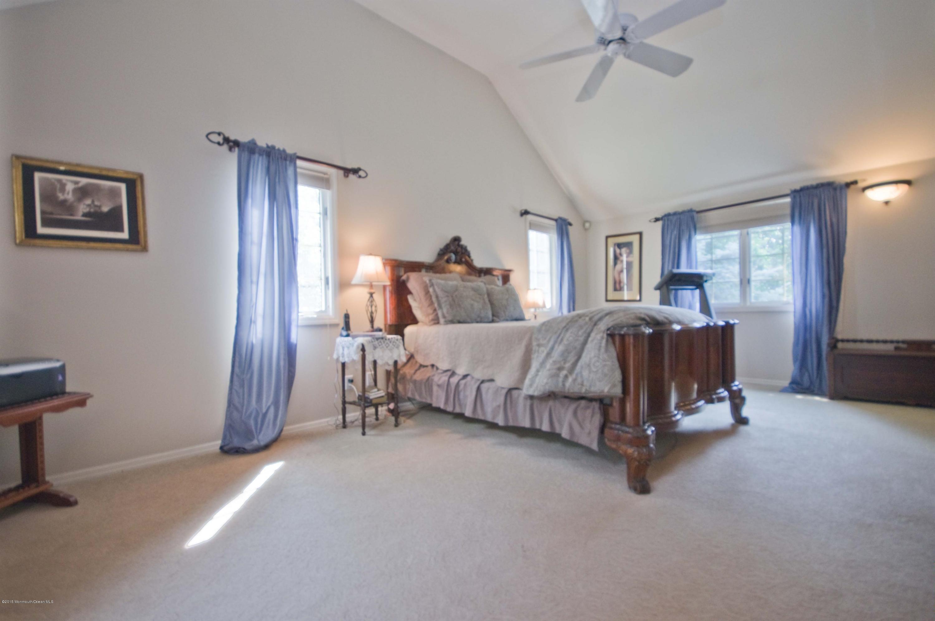 48 Crow Hill Road Freehold, NJ 07728 - Photo 14 of 29 a bedroom with a bed and a chandelier