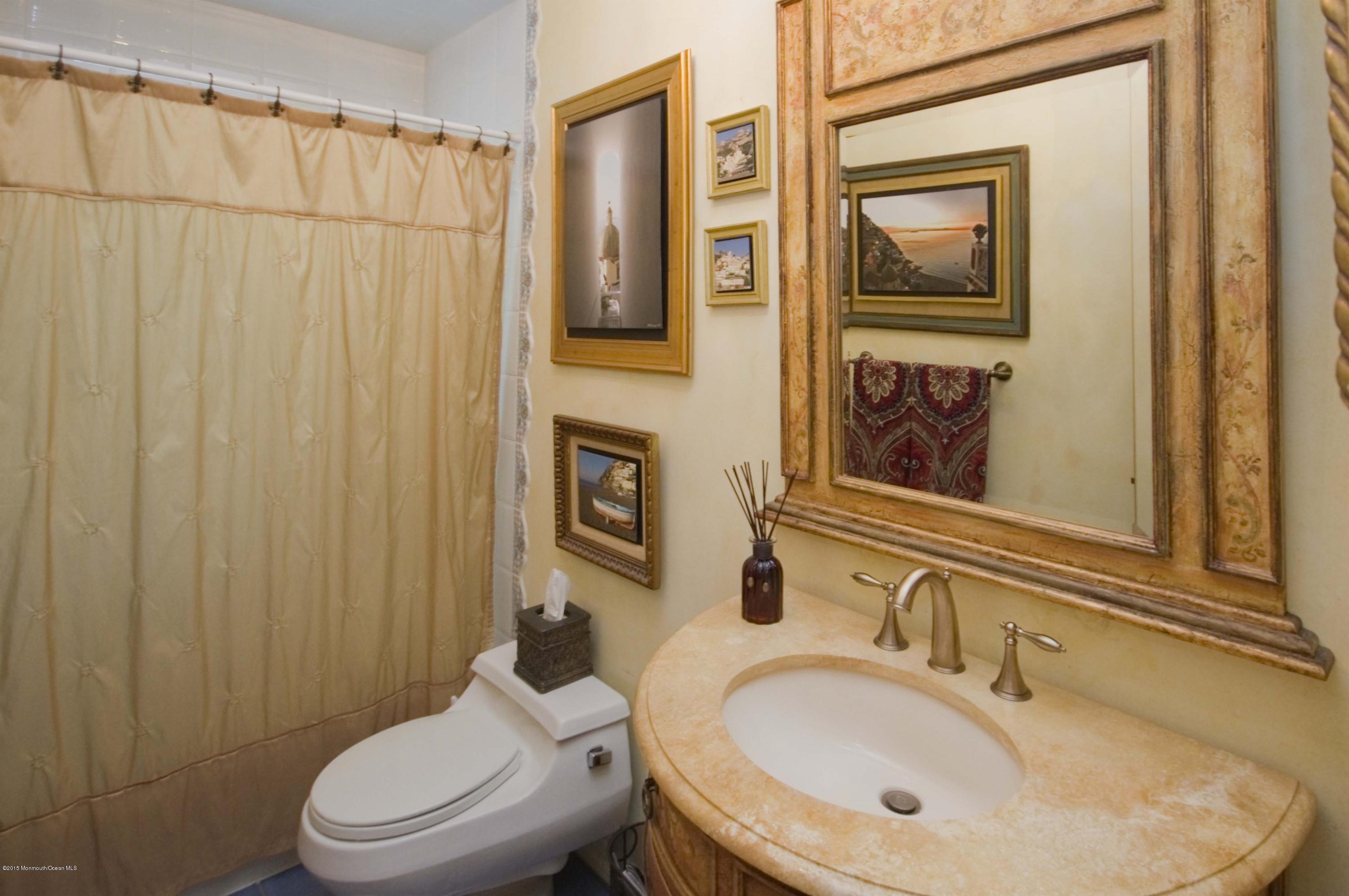 48 Crow Hill Road Freehold, NJ 07728 - Photo 18 of 29 a bathroom with a sink a toilet and shower curtain