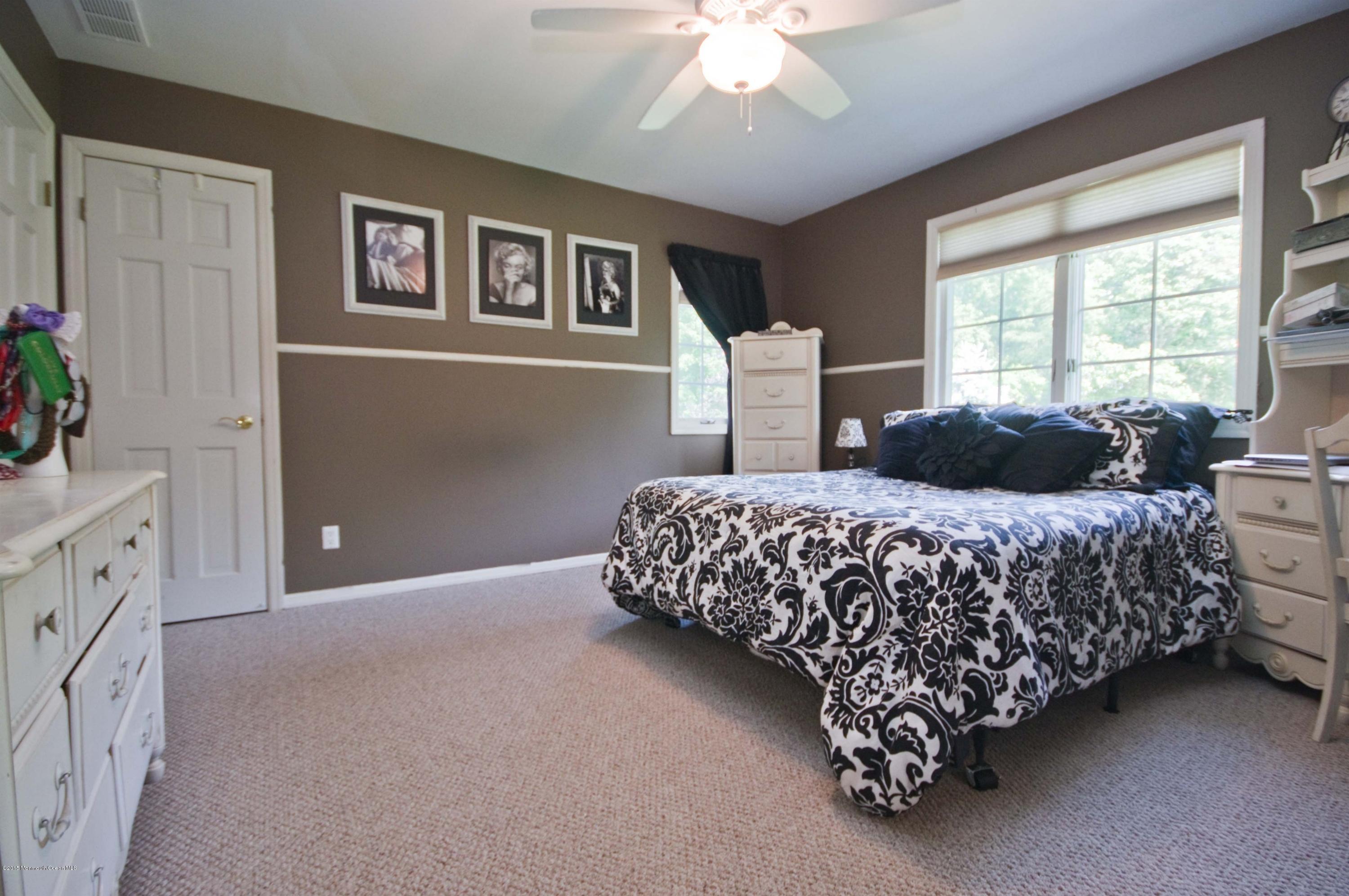 48 Crow Hill Road Freehold, NJ 07728 - Photo 21 of 29 a bedroom with a bed and a chandelier