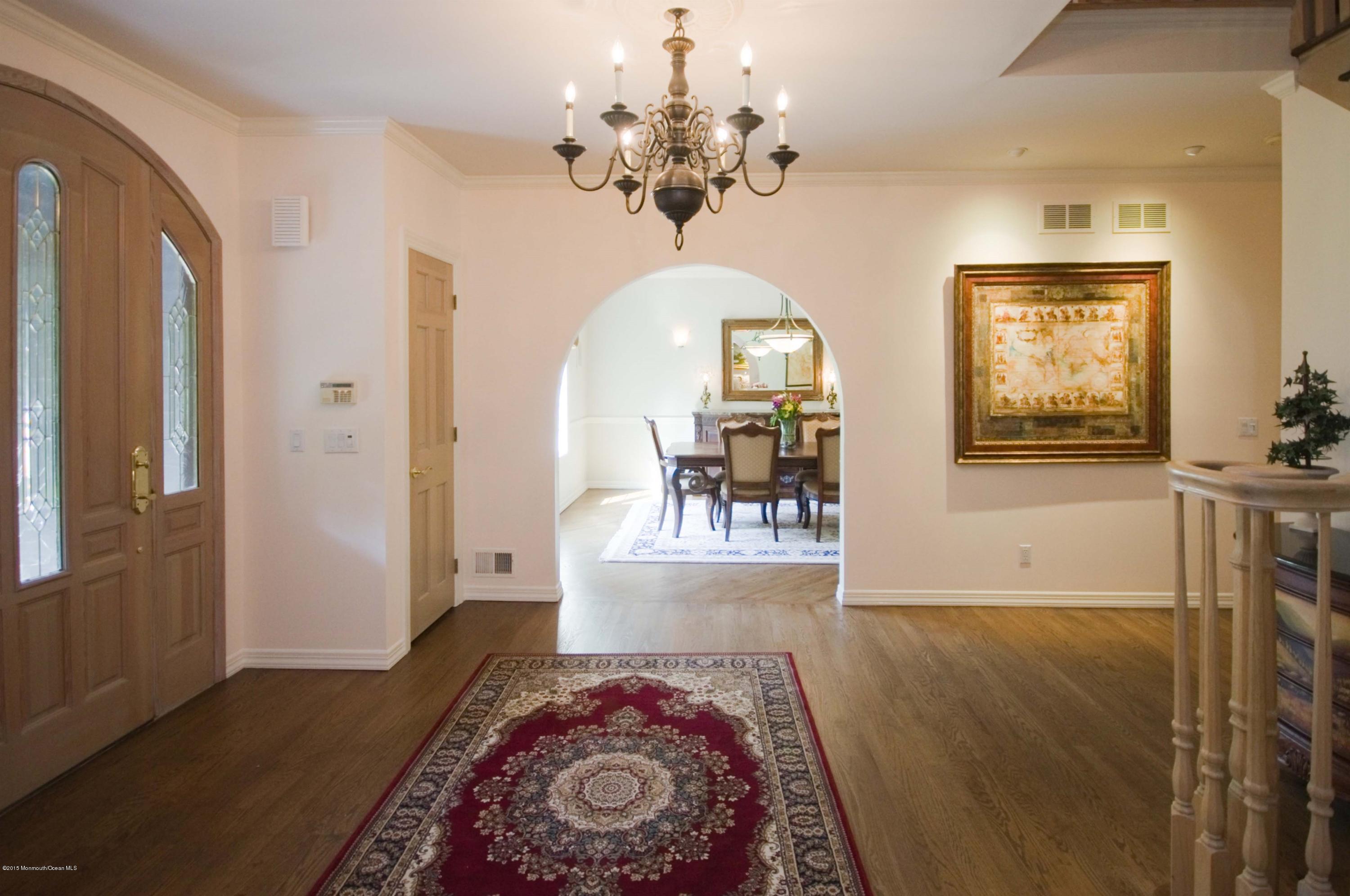 48 Crow Hill Road Freehold, NJ 07728 - Photo 5 of 29 a view of a livingroom with wooden floor and a chandelier