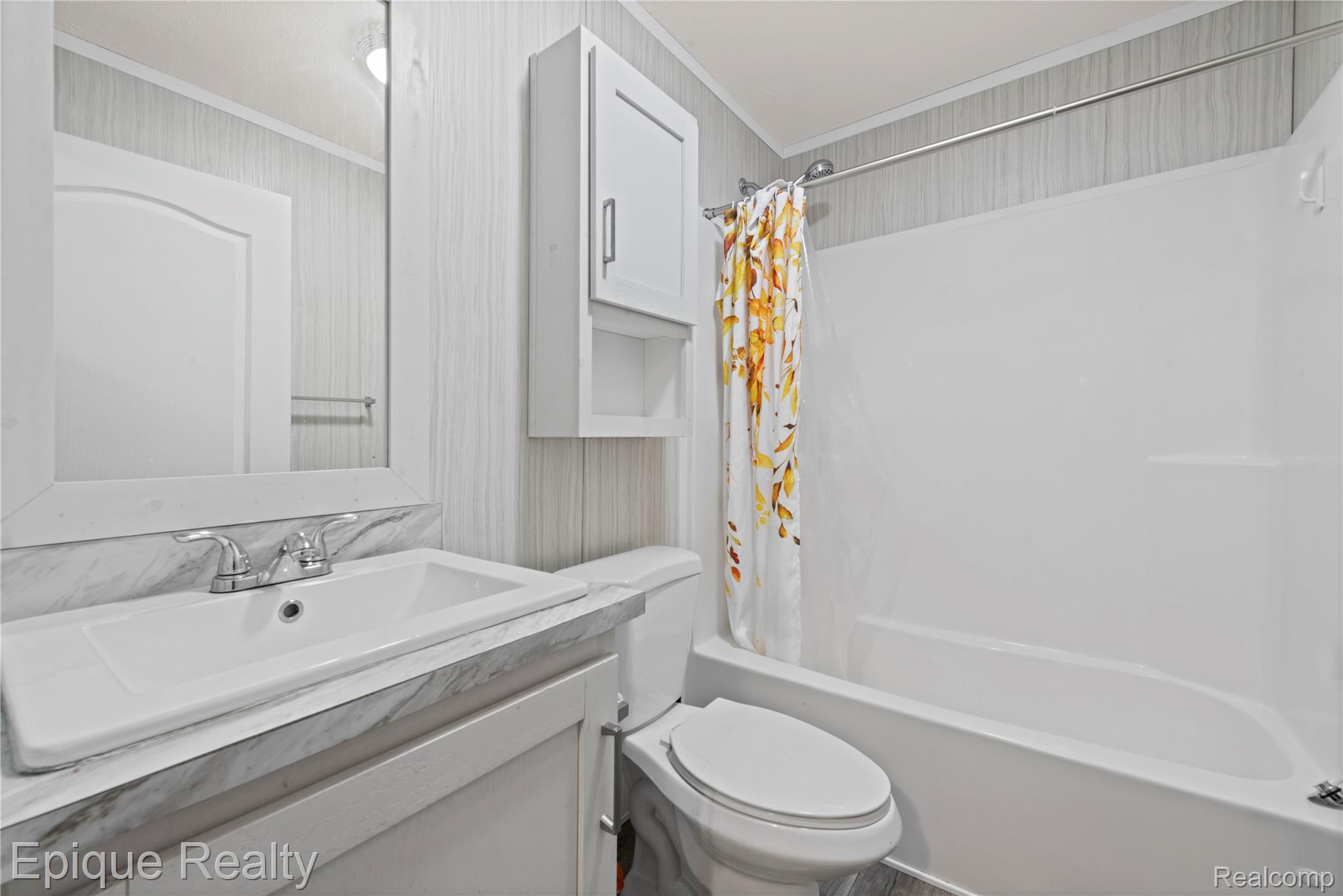 83 Elm Highland, MI 48357 - Photo 16 of 27 Full bath featuring vanity, shower / tub combo with curtain, crown molding, and wallpapered walls