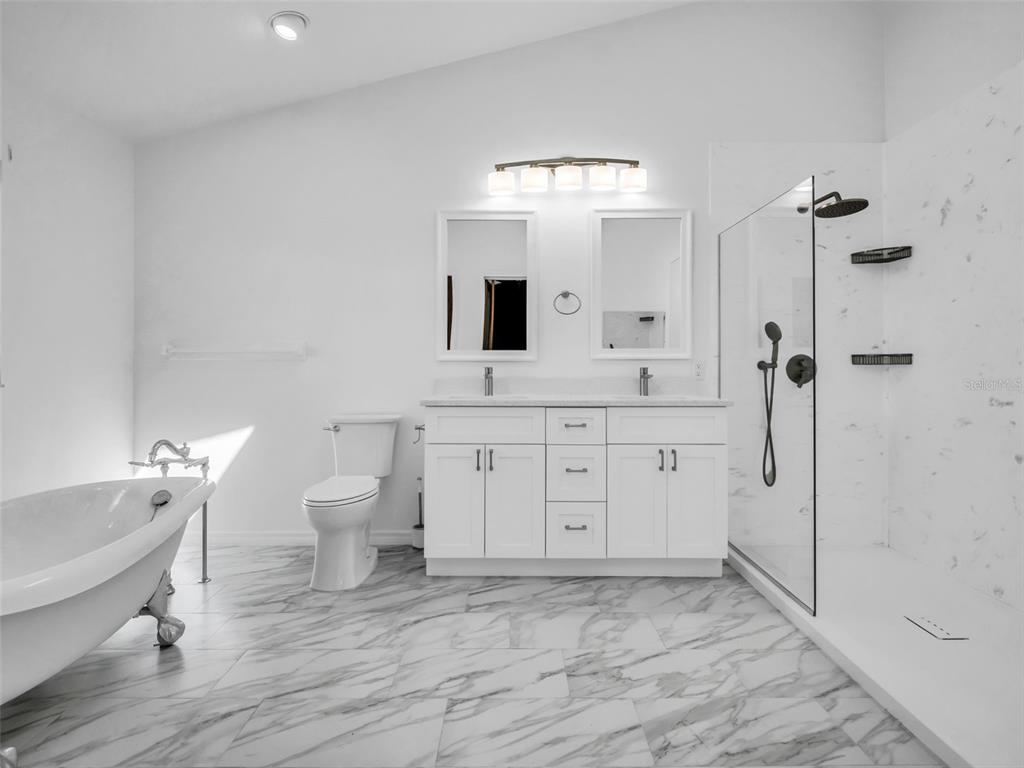 6241 Bayside Drive New Port Richey, FL 34652 - Photo 28 of 78 a bathroom with a sink a toilet and shower