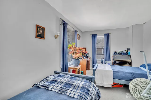 a bedroom with bed and a couch