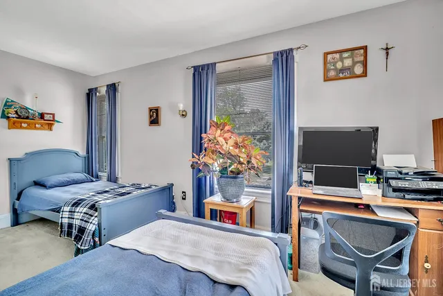 a bedroom with a bed and a desk