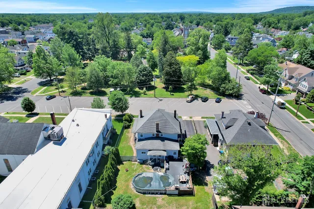 an aerial view of a house with a yard