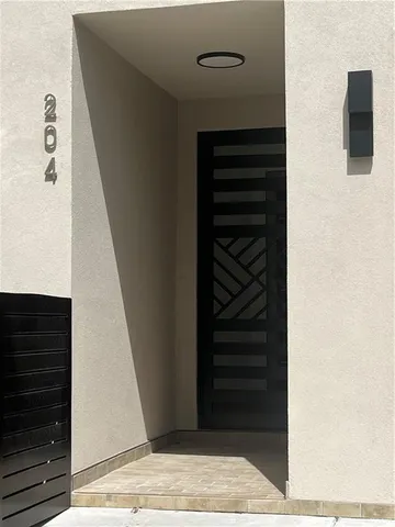 a kitchen with granite countertop a refrigerator and a stove top oven