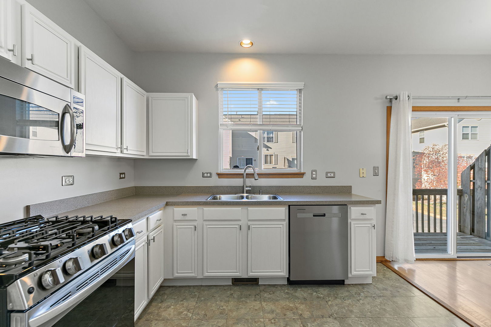 614 Littleton Trail Elgin, IL 60120 - Photo 14 of 29 a kitchen with stainless steel appliances granite countertop a stove and a sink