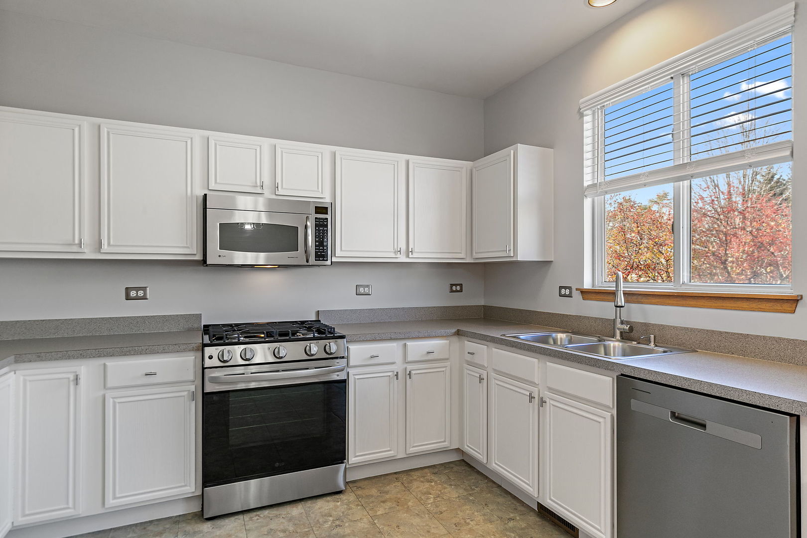 614 Littleton Trail Elgin, IL 60120 - Photo 15 of 29 a kitchen with stainless steel appliances granite countertop white cabinets a sink and a stove
