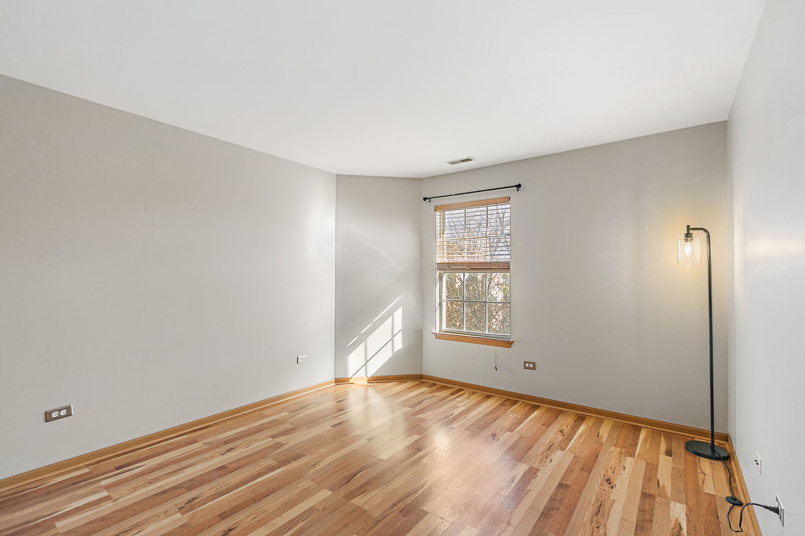 614 Littleton Trail Elgin, IL 60120 - Photo 18 of 29 an empty room with wooden floor and windows