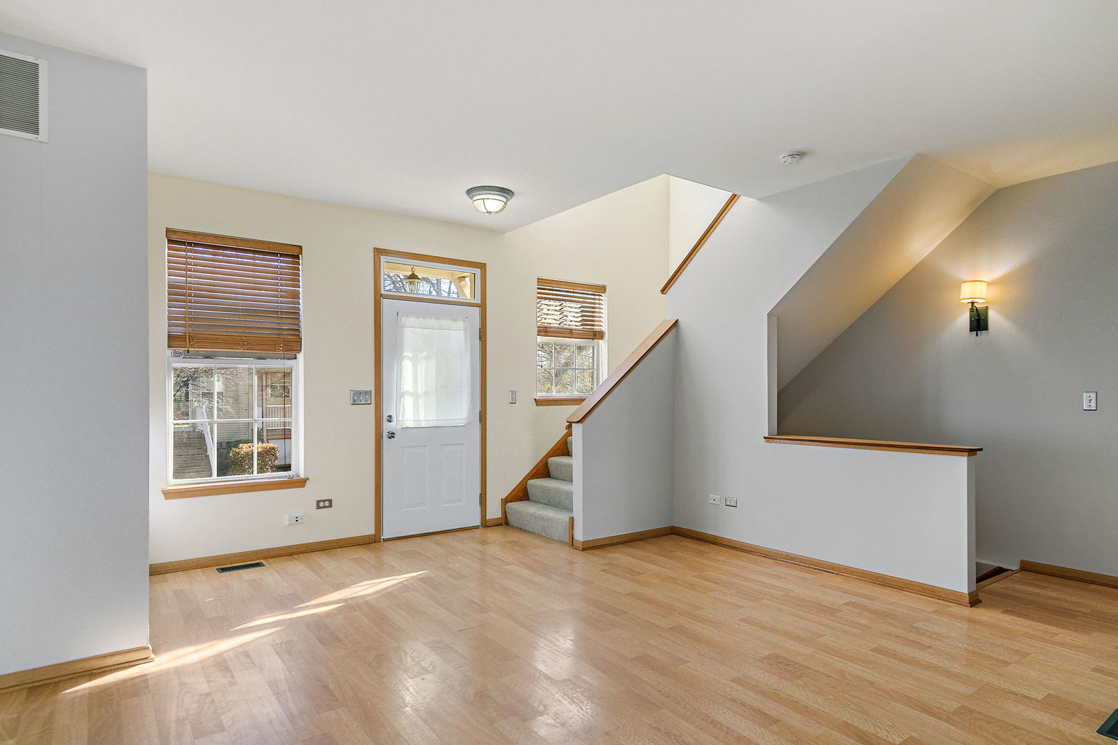 614 Littleton Trail Elgin, IL 60120 - Photo 4 of 29 a view of an empty room with wooden floor and a window
