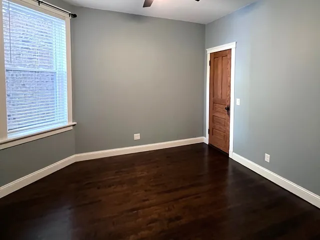 an empty room with wooden floor