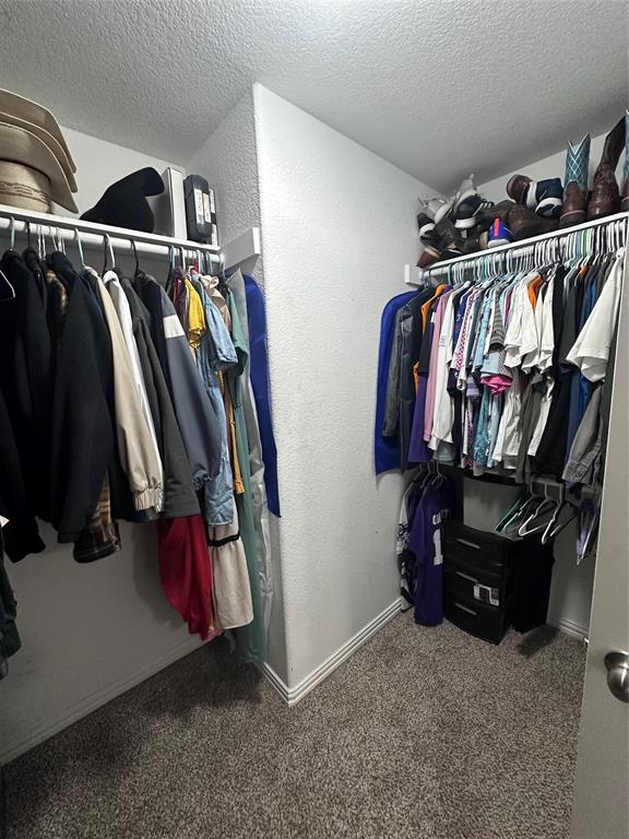 1212 Bowman Ridge Road Stephenville, TX 76401 - Photo 21 of 23 a view of walk in closet with clothes and shoes