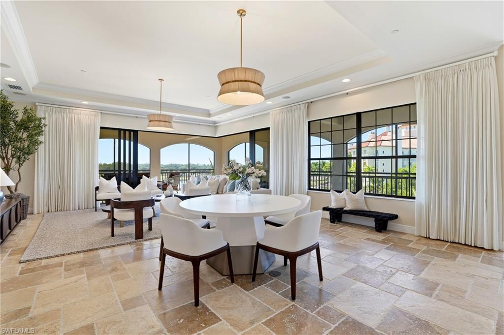 2546 Marquesa Royale Lane, Unit 7302 Naples, FL 34109 - Photo 12 of 46 a living room with furniture a window and a chandelier