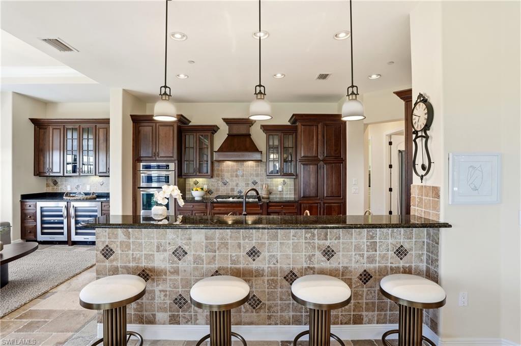 2546 Marquesa Royale Lane, Unit 7302 Naples, FL 34109 - Photo 14 of 46 a bathroom with a sink and a mirror