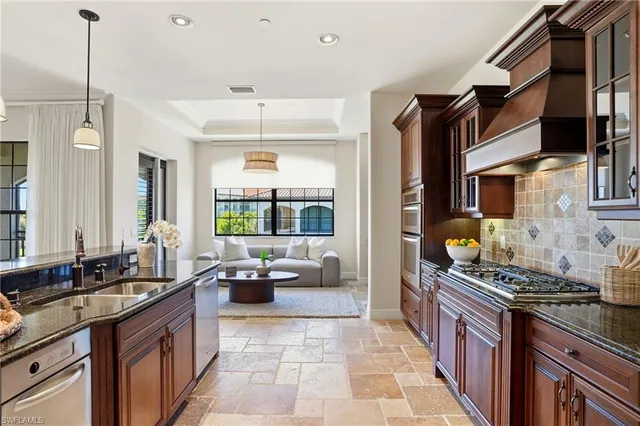 a kitchen with stainless steel appliances granite countertop a stove and a sink