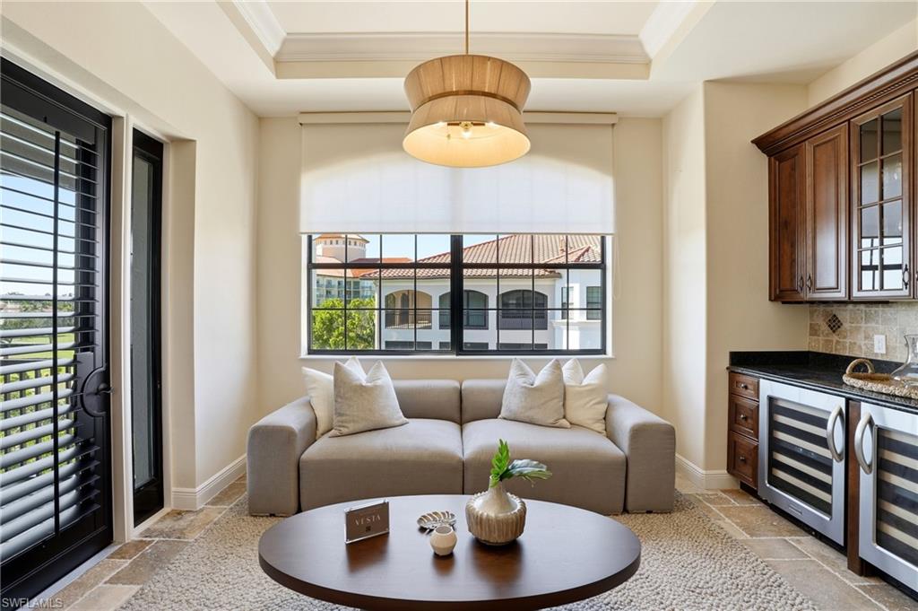2546 Marquesa Royale Lane, Unit 7302 Naples, FL 34109 - Photo 20 of 46 a living room with furniture and a window