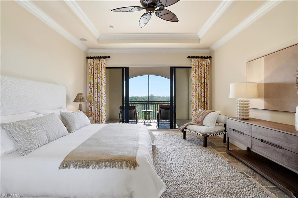 2546 Marquesa Royale Lane, Unit 7302 Naples, FL 34109 - Photo 22 of 46 a living room with furniture and a large window