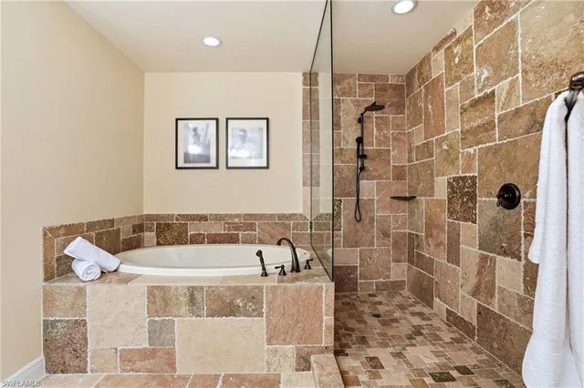 a bathroom with a bathtub and shower