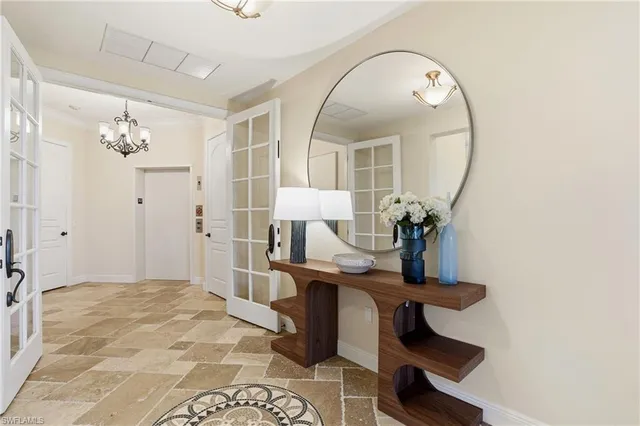a view of hall way with furniture and chandelier fan