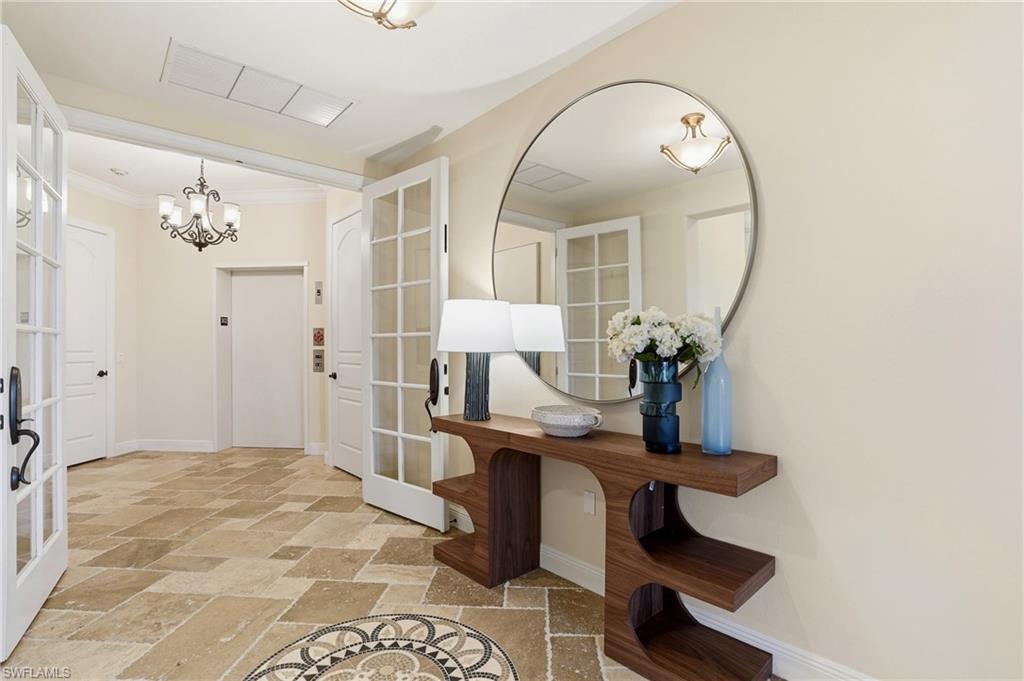 2546 Marquesa Royale Lane, Unit 7302 Naples, FL 34109 - Photo 3 of 46 a view of hall way with furniture and chandelier fan
