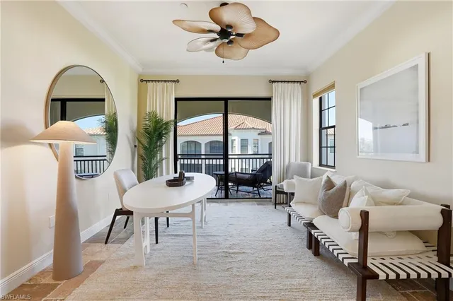 a living room with furniture a table and chairs
