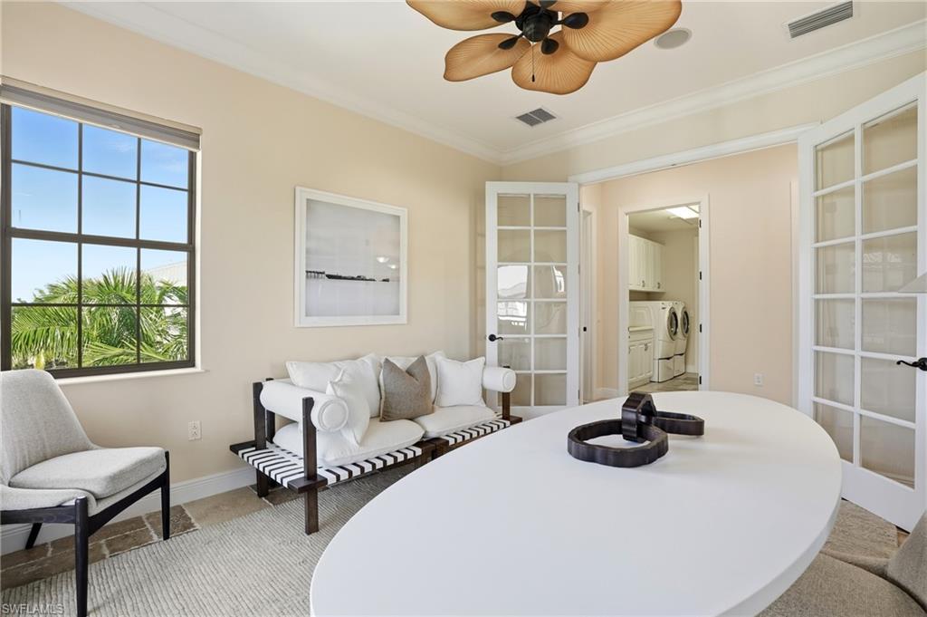 2546 Marquesa Royale Lane, Unit 7302 Naples, FL 34109 - Photo 33 of 46 a bedroom with a bed and a table