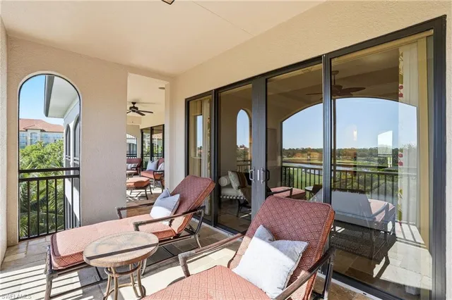 a living room with furniture fireplace and a large window