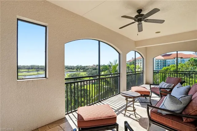 a living room with furniture and a floor to ceiling window